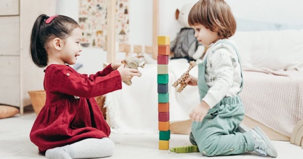 Two small children playing blocks at daycare